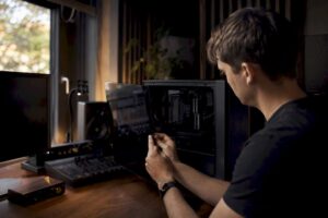 Iemand start zijn studio-pc op om problemen met de plugins op te lossen.